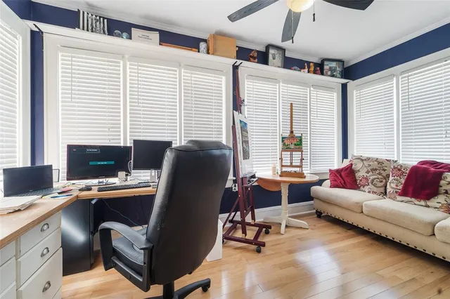 a view of a workspace with furniture and a window