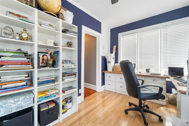 a view of a workspace with furniture and a window