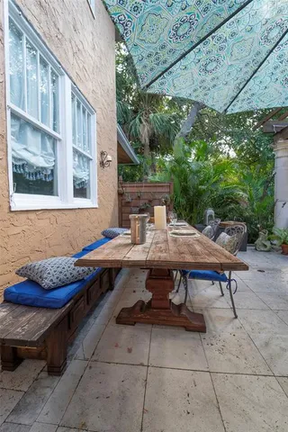a roof deck with a table and chairs