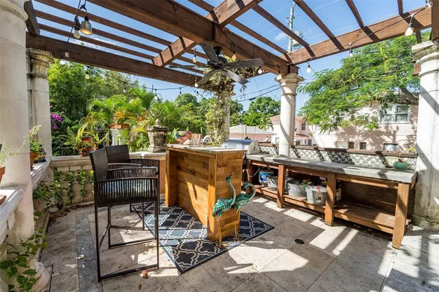 a view of a patio with table and chairs and potted plants