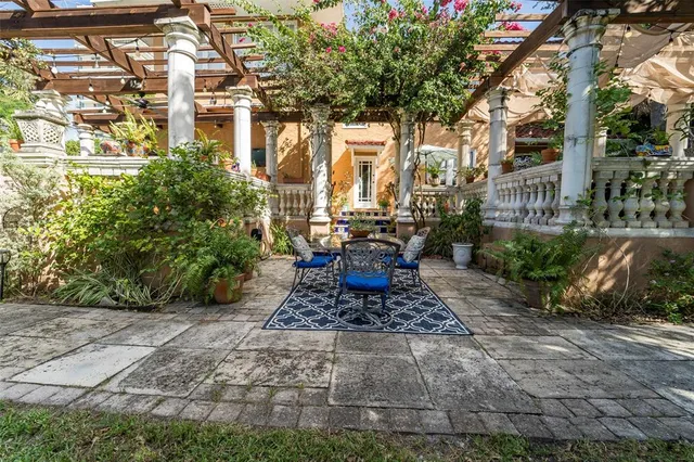 a view of a patio with table and chairs and potted plants