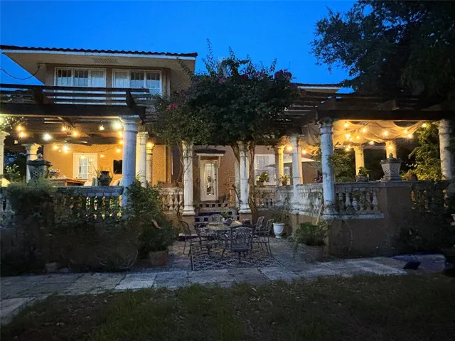 a view of patio with table and chairs and potted plants