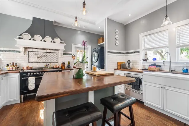 a kitchen with a table chairs stove and cabinets