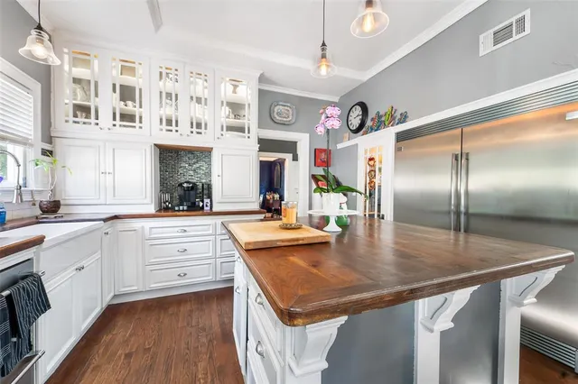 a kitchen with stainless steel appliances granite countertop a sink refrigerator and cabinets