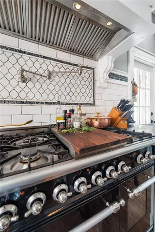 a stove top oven sitting inside of a kitchen