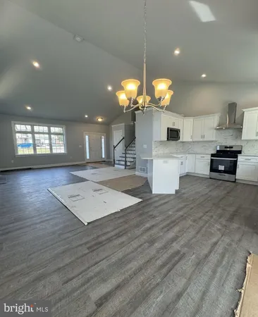 a kitchen with stainless steel appliances a sink stove and cabinets