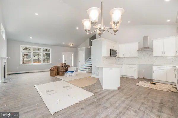 a kitchen with a sink and wooden floor