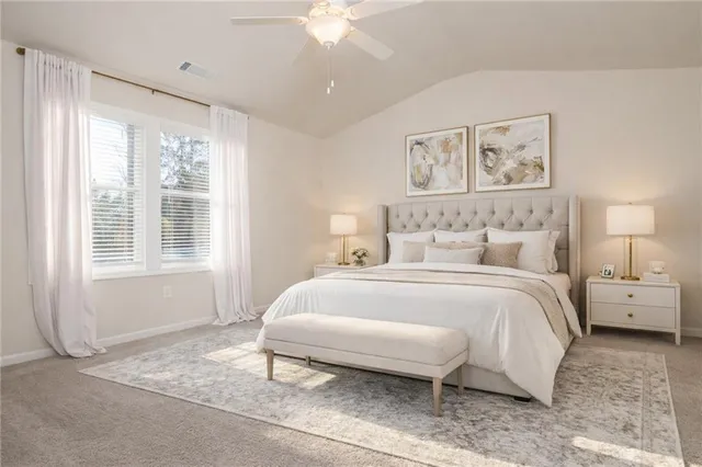 a spacious bedroom with a bed and a large window