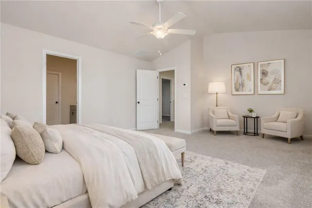 a spacious bedroom with a bed and a chandelier