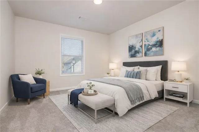 a spacious bedroom with a bed and a couch