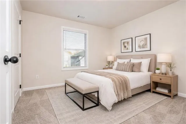 a spacious bedroom with a bed and a window