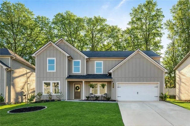 a front view of house with yard and green space