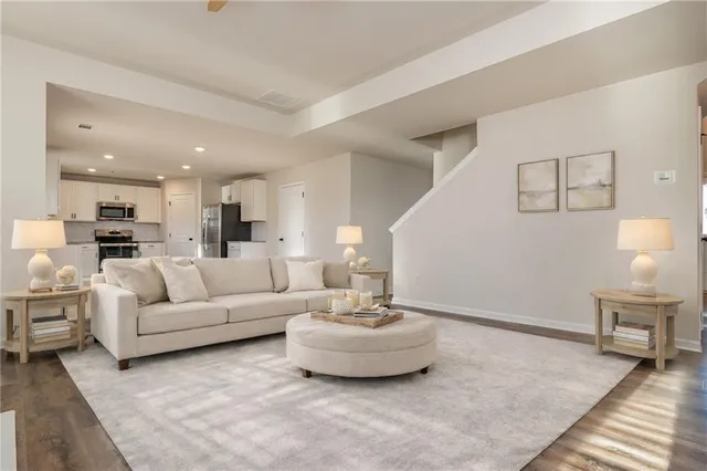 a living room with furniture and a wooden floor
