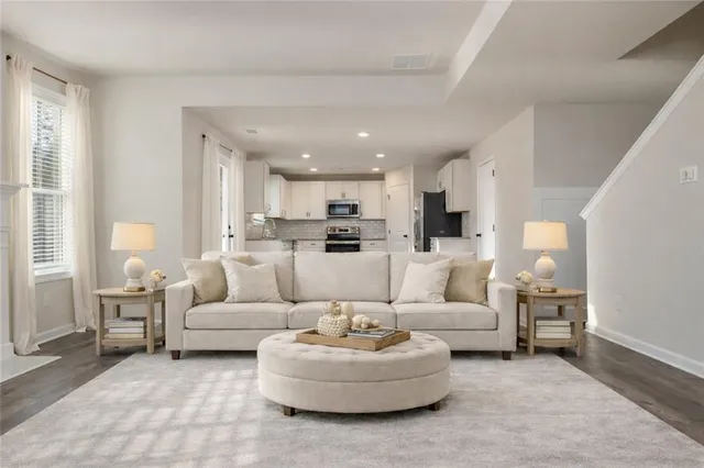 a living room with furniture and kitchen view