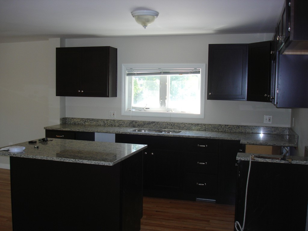 1 Lancaster Road Shirley, MA 01464 - Photo 11 of 30 a kitchen with a sink stove and microwave