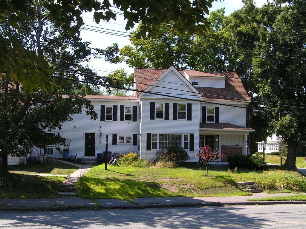 1 Lancaster Road Shirley, MA 01464 - Photo 23 of 30 a front view of a house with a yard table and chairs