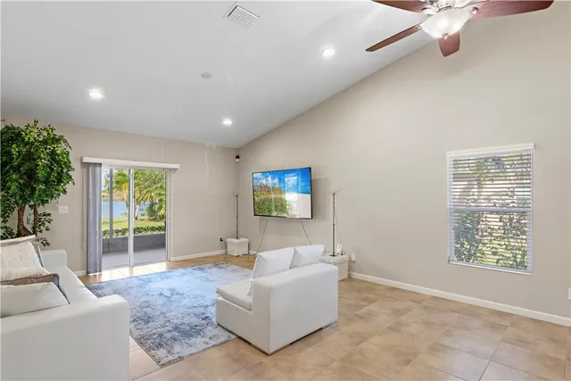 a bedroom with a bed a window and a chandelier