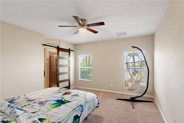 a bathroom with a granite countertop tub sink and mirror