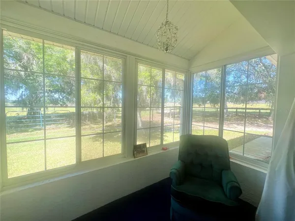 a view of a house with backyard and porch