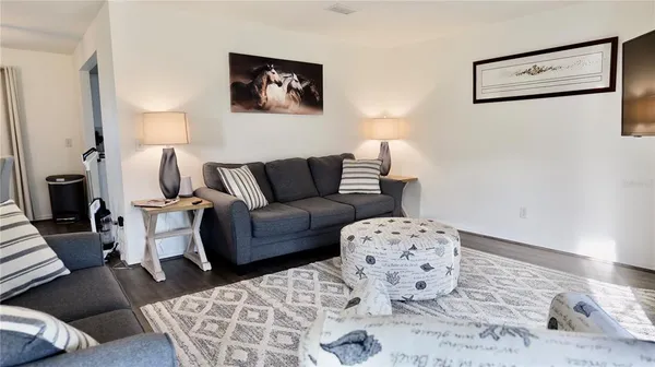 a spacious bedroom with a bed and a flat screen tv