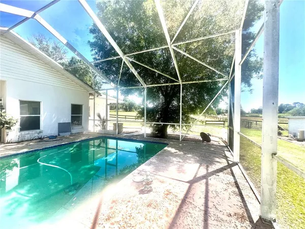 a view of a house with a yard and sitting area