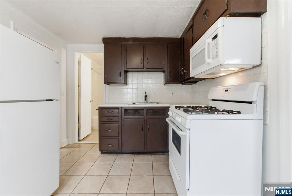 64 John Ryle Avenue Haledon, NJ 07508 - Photo 18 of 44 a kitchen with stainless steel appliances granite countertop a stove a refrigerator and a refrigerator