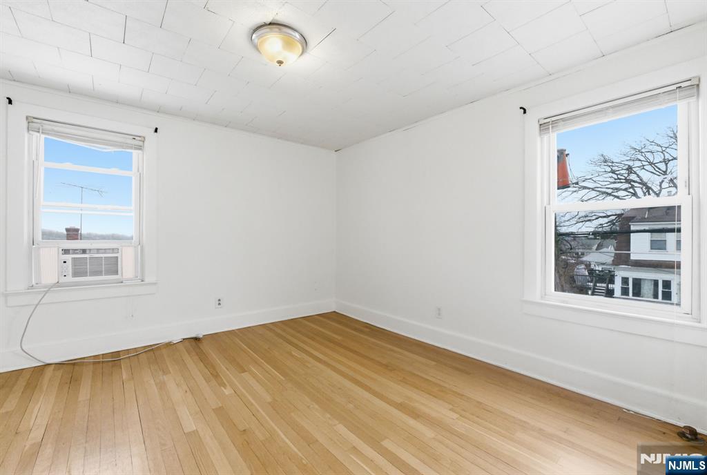 64 John Ryle Avenue Haledon, NJ 07508 - Photo 23 of 44 a view of empty room with wooden floor and fan