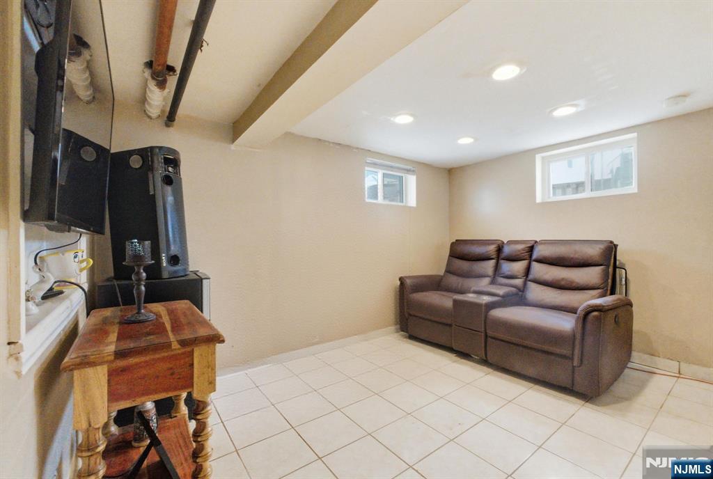64 John Ryle Avenue Haledon, NJ 07508 - Photo 26 of 44 a living room with furniture a air conditioner vent and a window