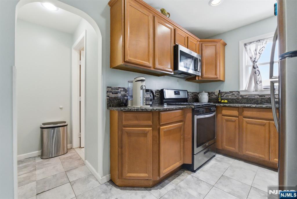 64 John Ryle Avenue Haledon, NJ 07508 - Photo 6 of 44 a kitchen with stainless steel appliances granite countertop a refrigerator stove and sink