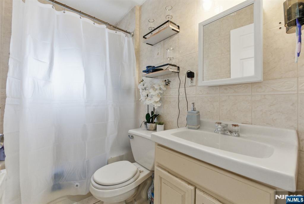 64 John Ryle Avenue Haledon, NJ 07508 - Photo 9 of 44 a bathroom with a sink a toilet and shower