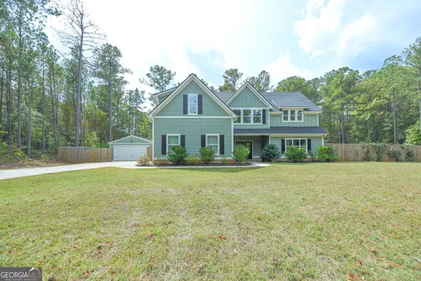 a front view of a house with a yard