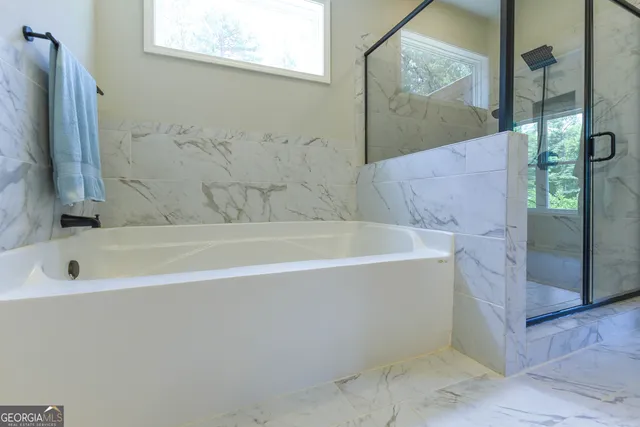 a bathroom with a bathtub and shower