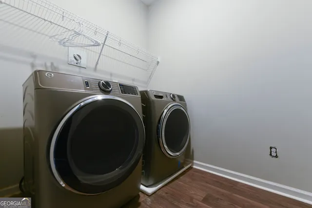 a white building with a bench and potted plant