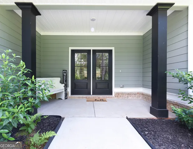 a view of backyard with wooden fence