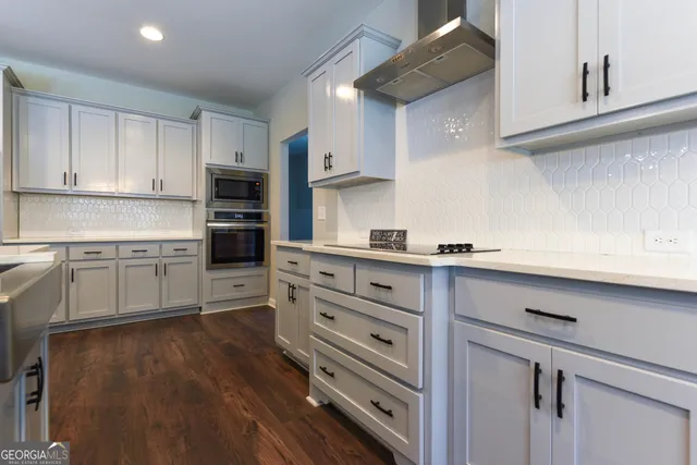 a kitchen with kitchen island white cabinets and white appliances