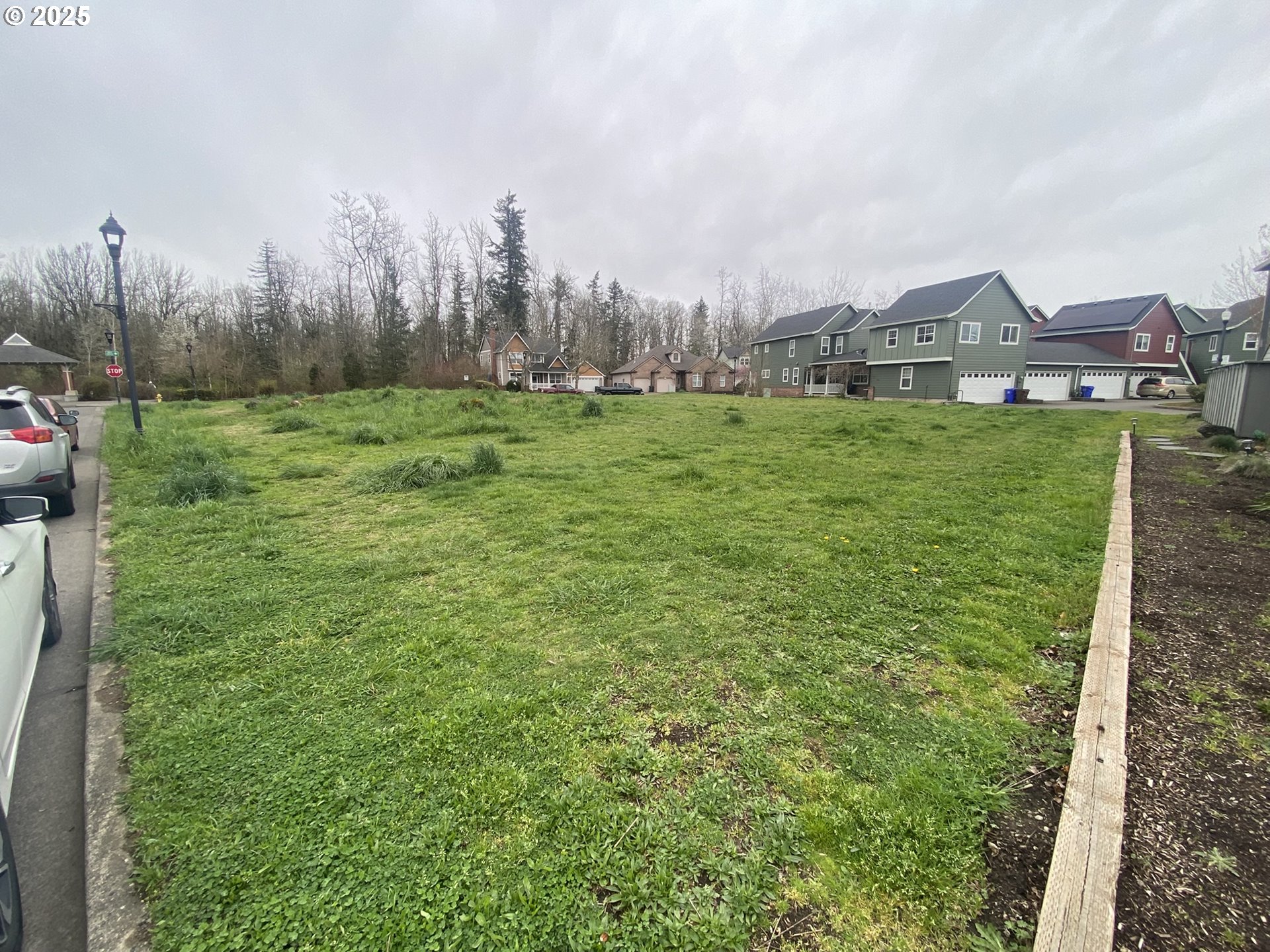 1305 Northeast Village Street Fairview, OR 97024 - Photo 3 of 11 a view of a house with a big yard and large trees