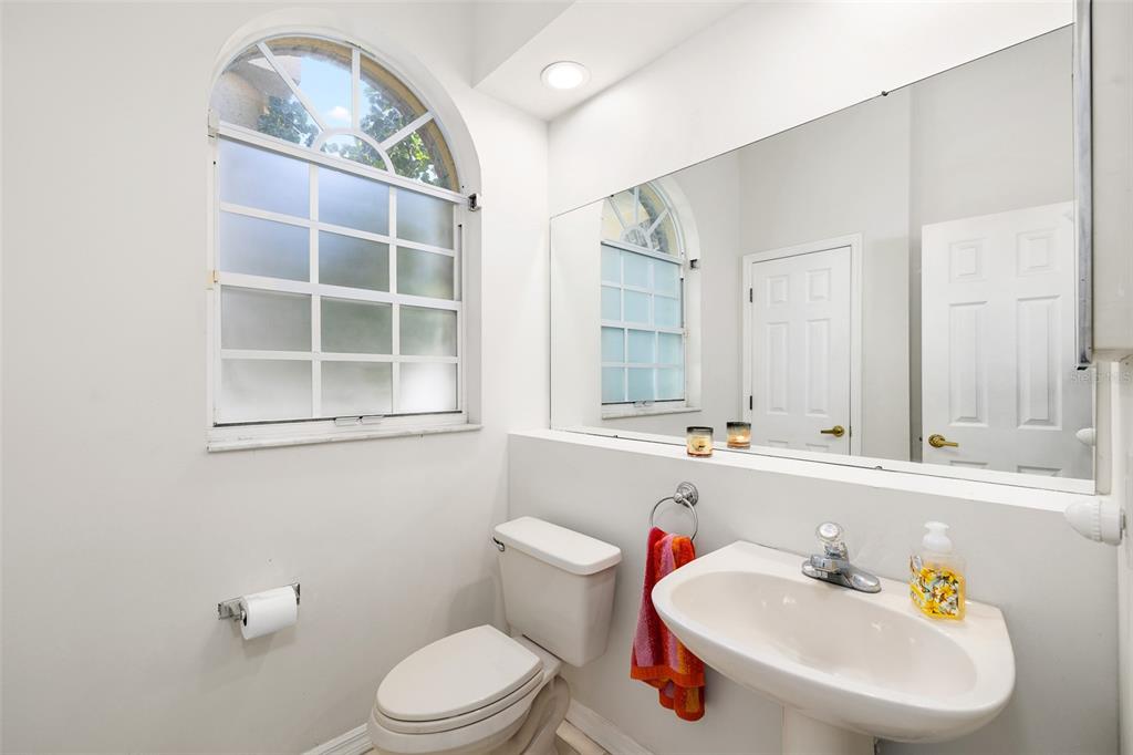 2513 Regal River Road Valrico, FL 33596 - Photo 34 of 46 a bathroom with a sink a toilet and mirror