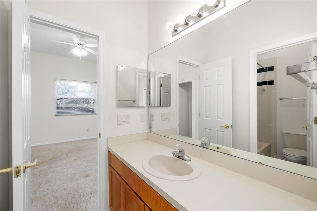 2513 Regal River Road Valrico, FL 33596 - Photo 35 of 46 a bathroom with a sink double vanity granite tub shower and a mirror