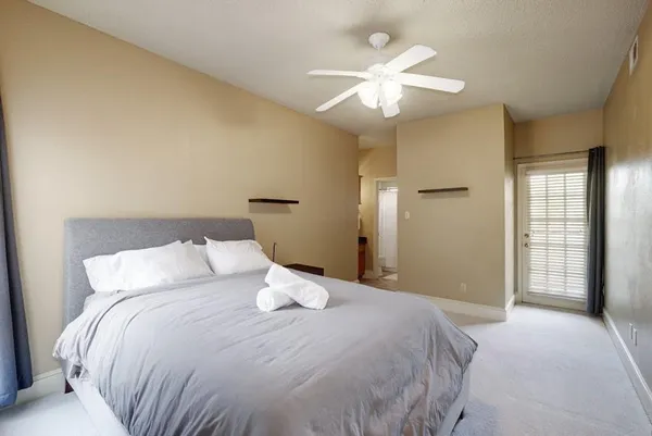 a bedroom with a large bed and a chandelier