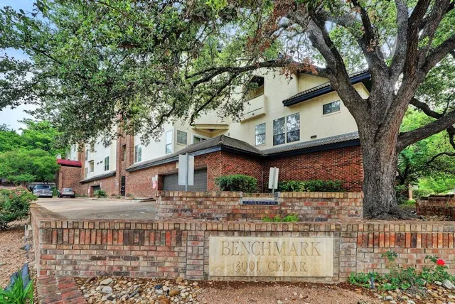 a front view of a house with a tree