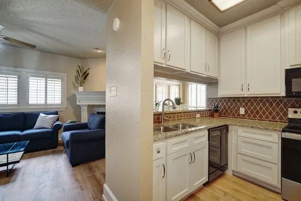 a kitchen with cabinets appliances and a window