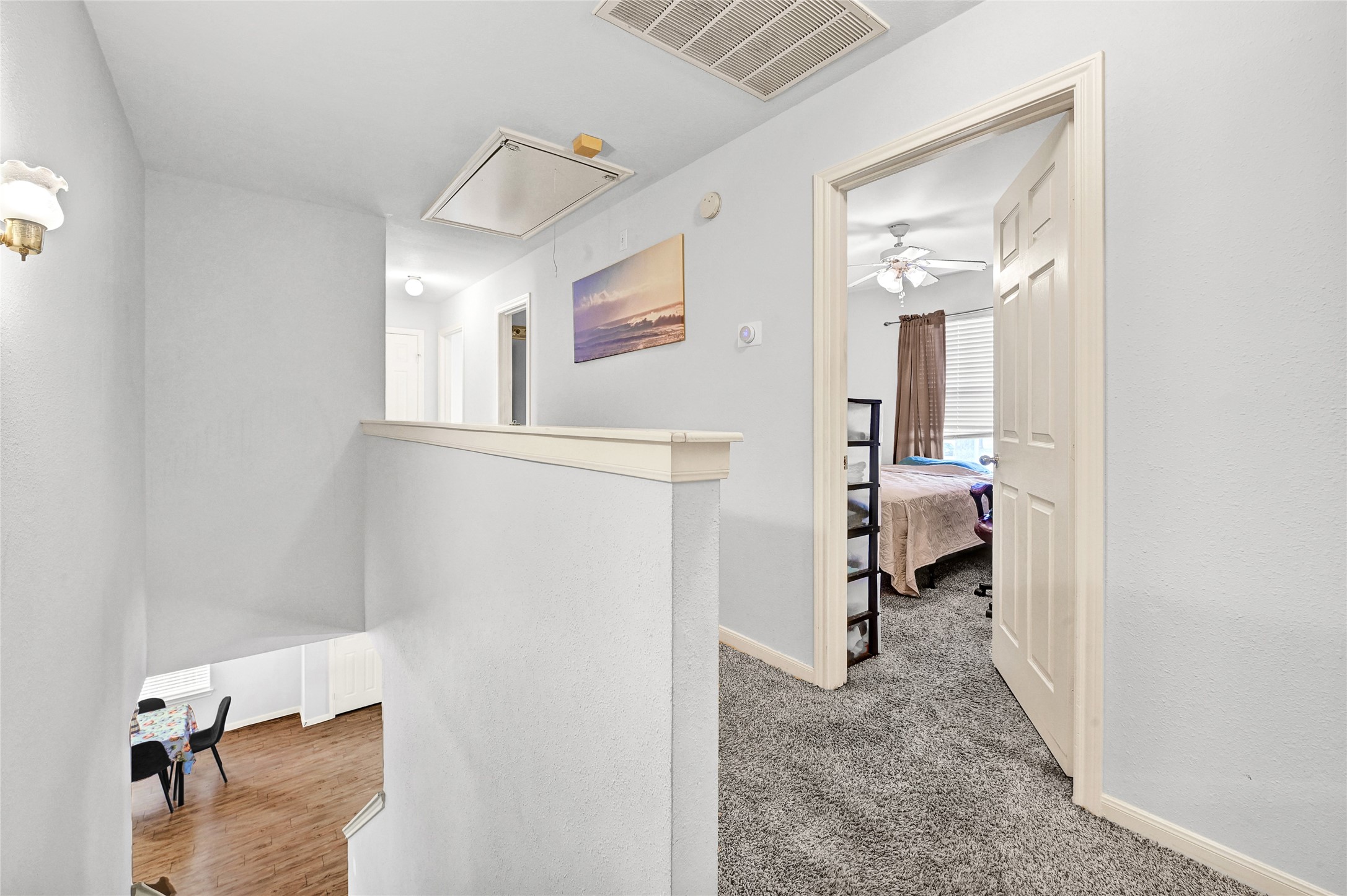 10100 Spring Pl Drive Houston, TX 77070 - Photo 11 of 24 a view of a hallway with paintings on the wall