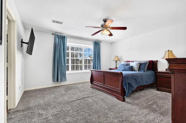 a bedroom with a bed and a television