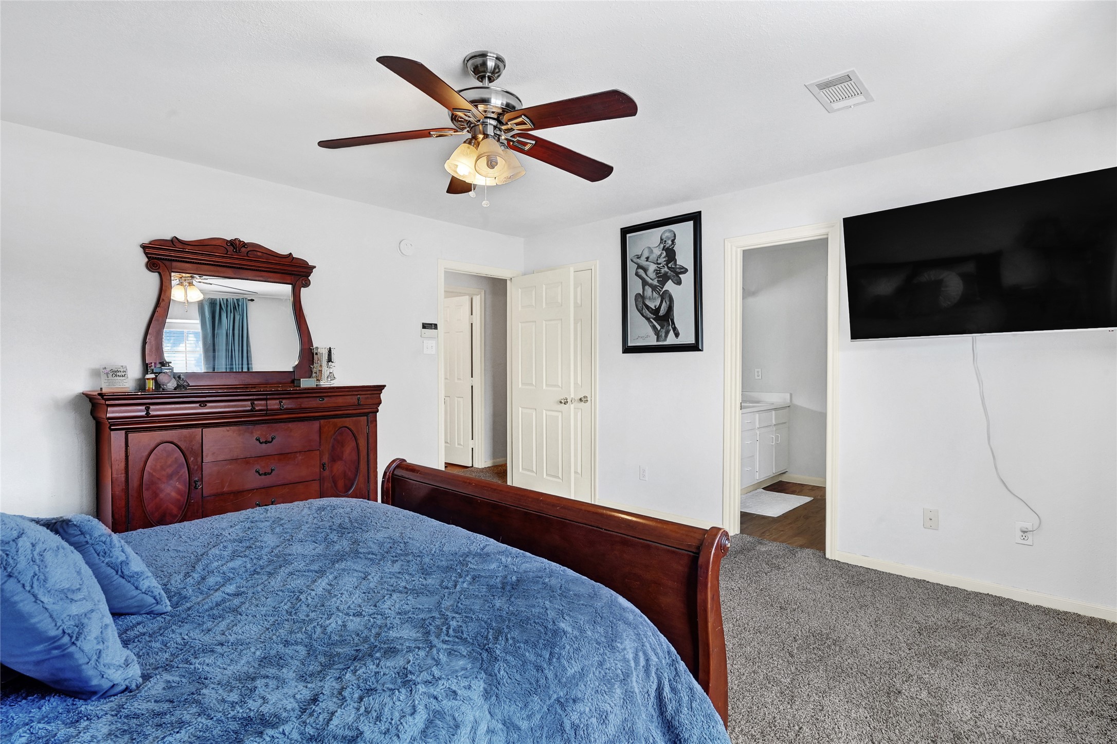 10100 Spring Pl Drive Houston, TX 77070 - Photo 13 of 24 a bedroom with a bed and a television