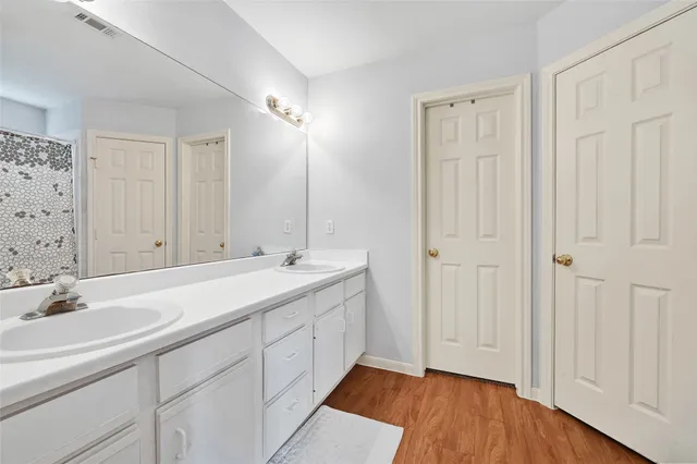 a bathroom with a bathtub a shower and a window