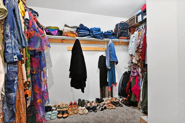 a bedroom with a bed and a chair