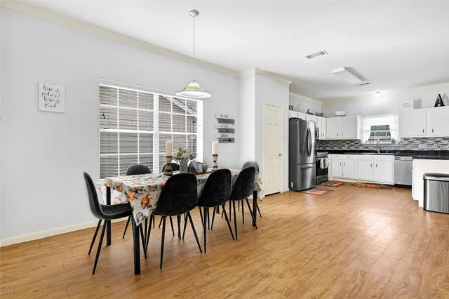 a view of a dining room with furniture and wooden floor