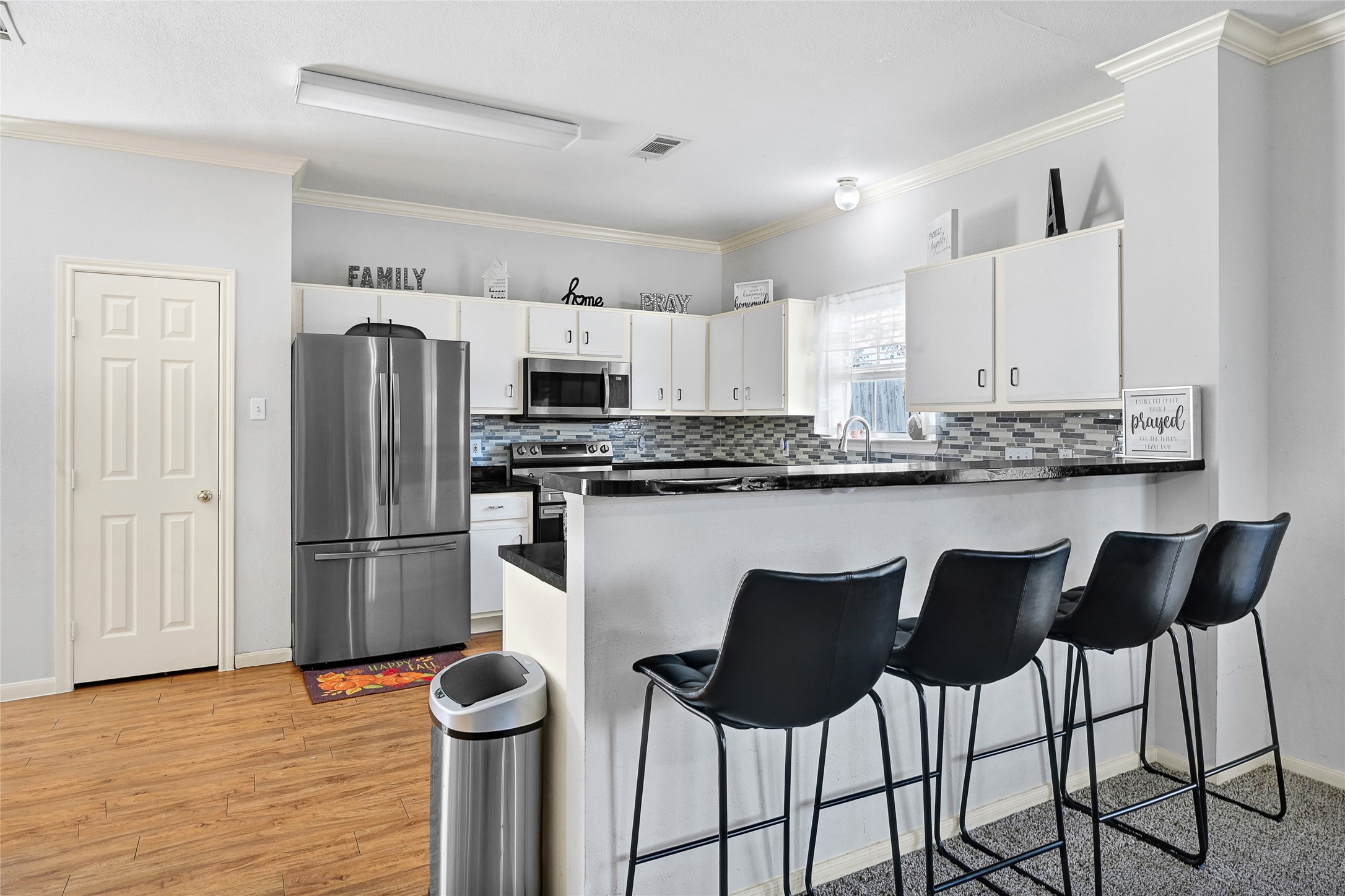 10100 Spring Pl Drive Houston, TX 77070 - Photo 8 of 24 a kitchen with stainless steel appliances granite countertop a refrigerator and a stove top oven