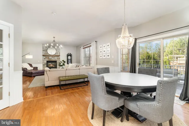 a living room with furniture a table and a chandelier