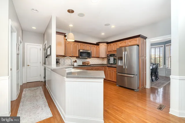 a kitchen with refrigerator cabinets and wooden floor